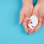 Holding a stomach in the hand, inflammation digestive system, gastrointestinal health issues